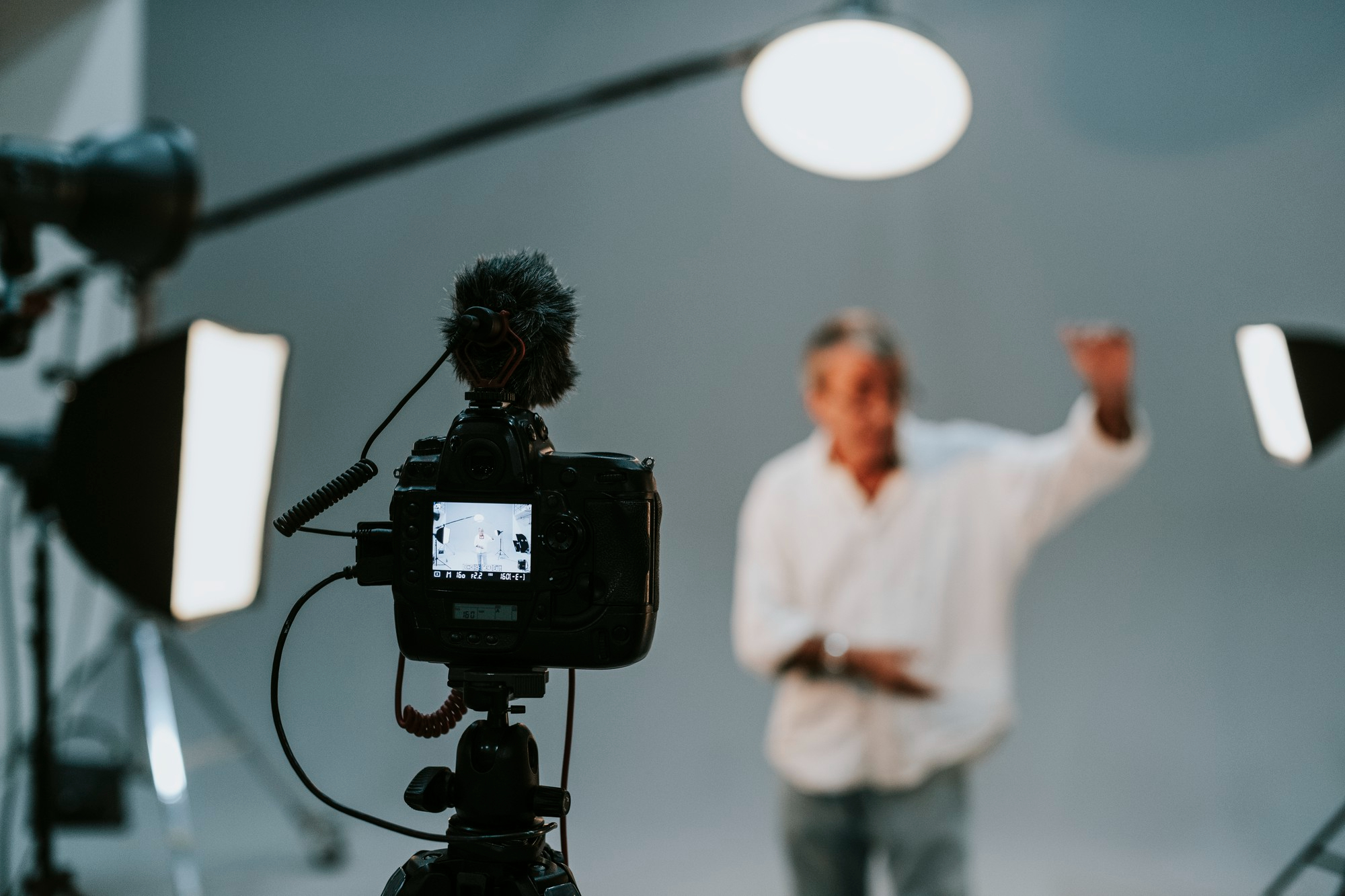 "Camera focused on a presenter during a video production session at Marketopia"