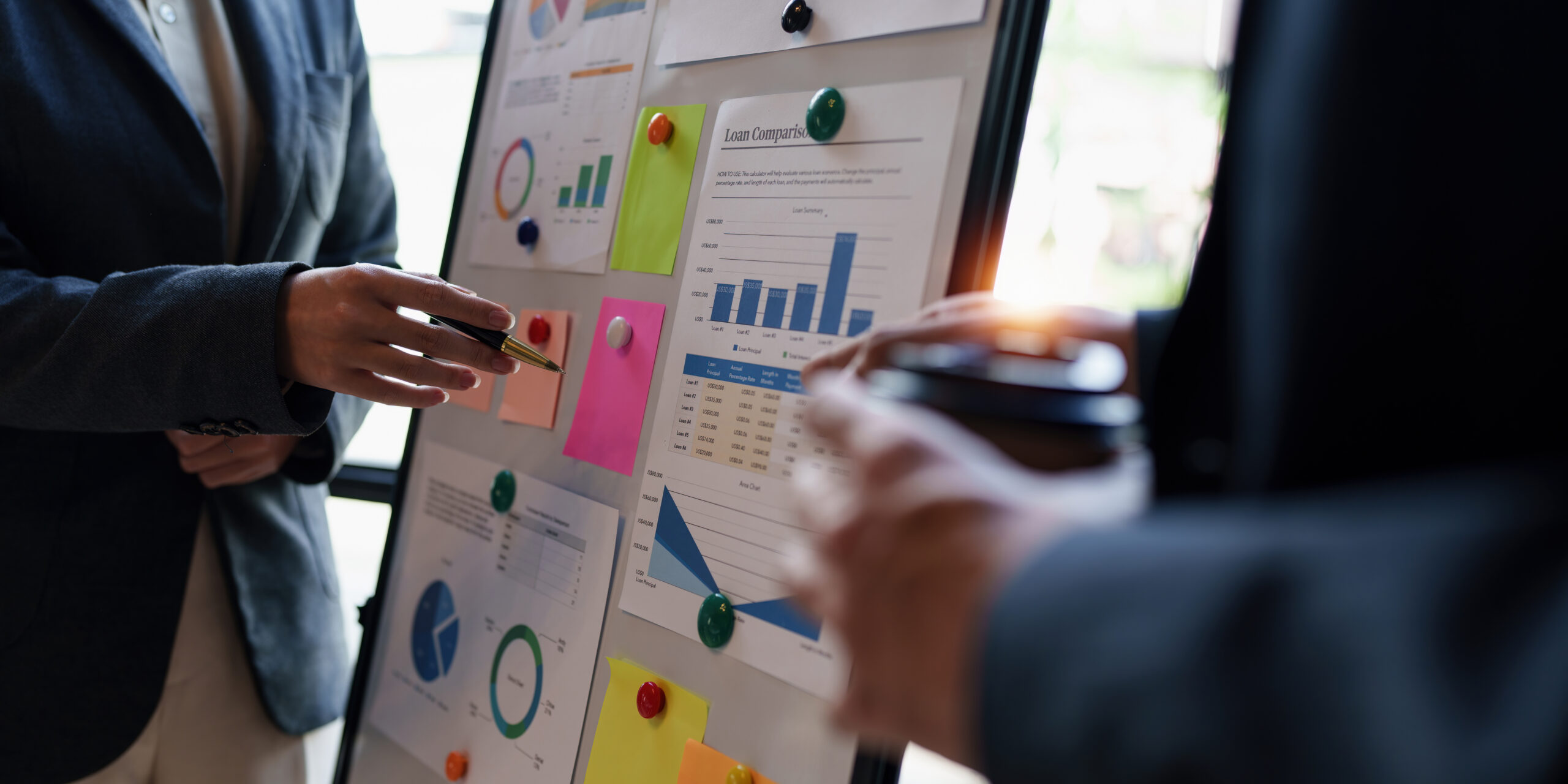 "Marketopia professionals discussing marketing data displayed on a presentation board"